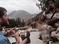 Brandon (left) is listening to the music being played by a paralyzed man from Hunza Valley in Pakistan.