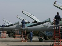 The photo shows Russian Air Force technicians preparing MiG 29 jet fighters in Primorsko-Akhtarsk